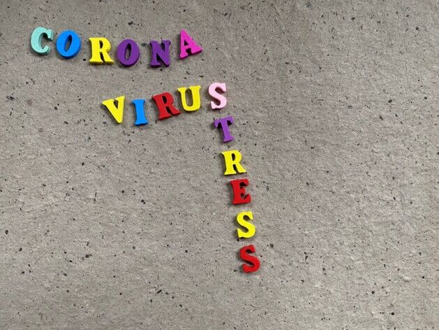 Multicolored letters on a gray background spell "CORONA VIRUS" vertically and "STRESS" horizontally intersecting at "S", resembling signs seen in a medical urgent care clinic.